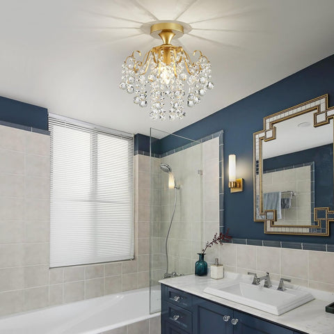Bathroom with a gold chandelier, blue walls, and a shower area.