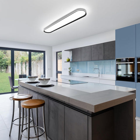Modern kitchen with a island, stools, and large windows.