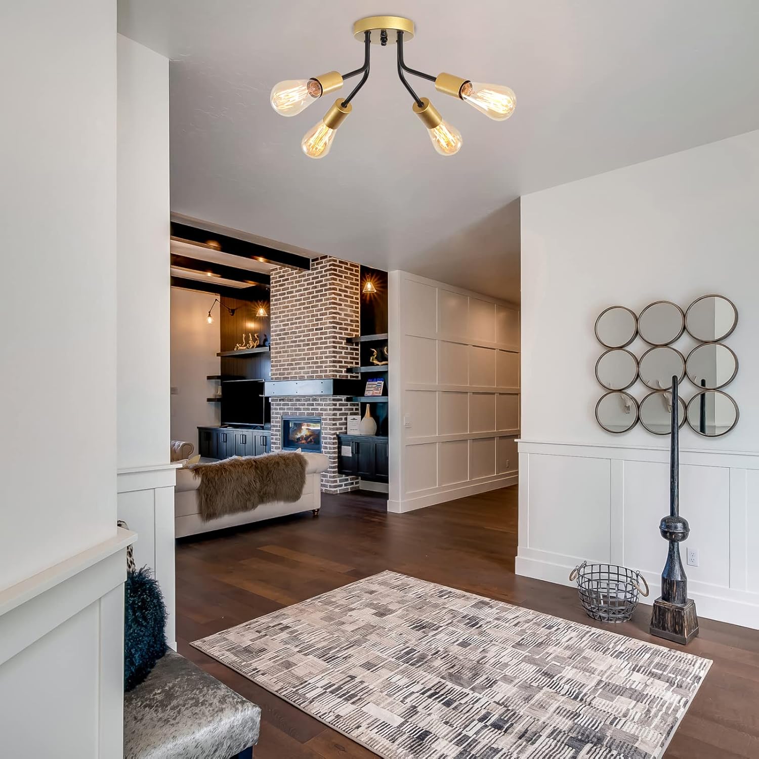 Modern living room with a stylish chandelier, rug, and decorative wall art.