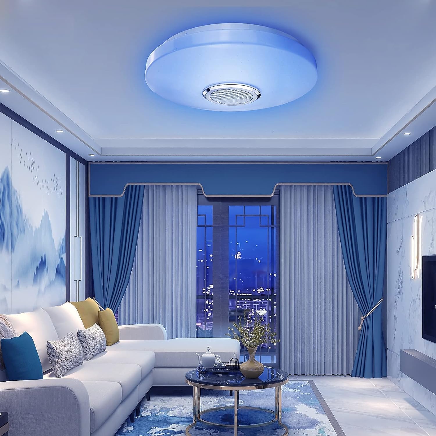 Modern living room with blue ceiling light fixture, white sofa, and cityscape view.