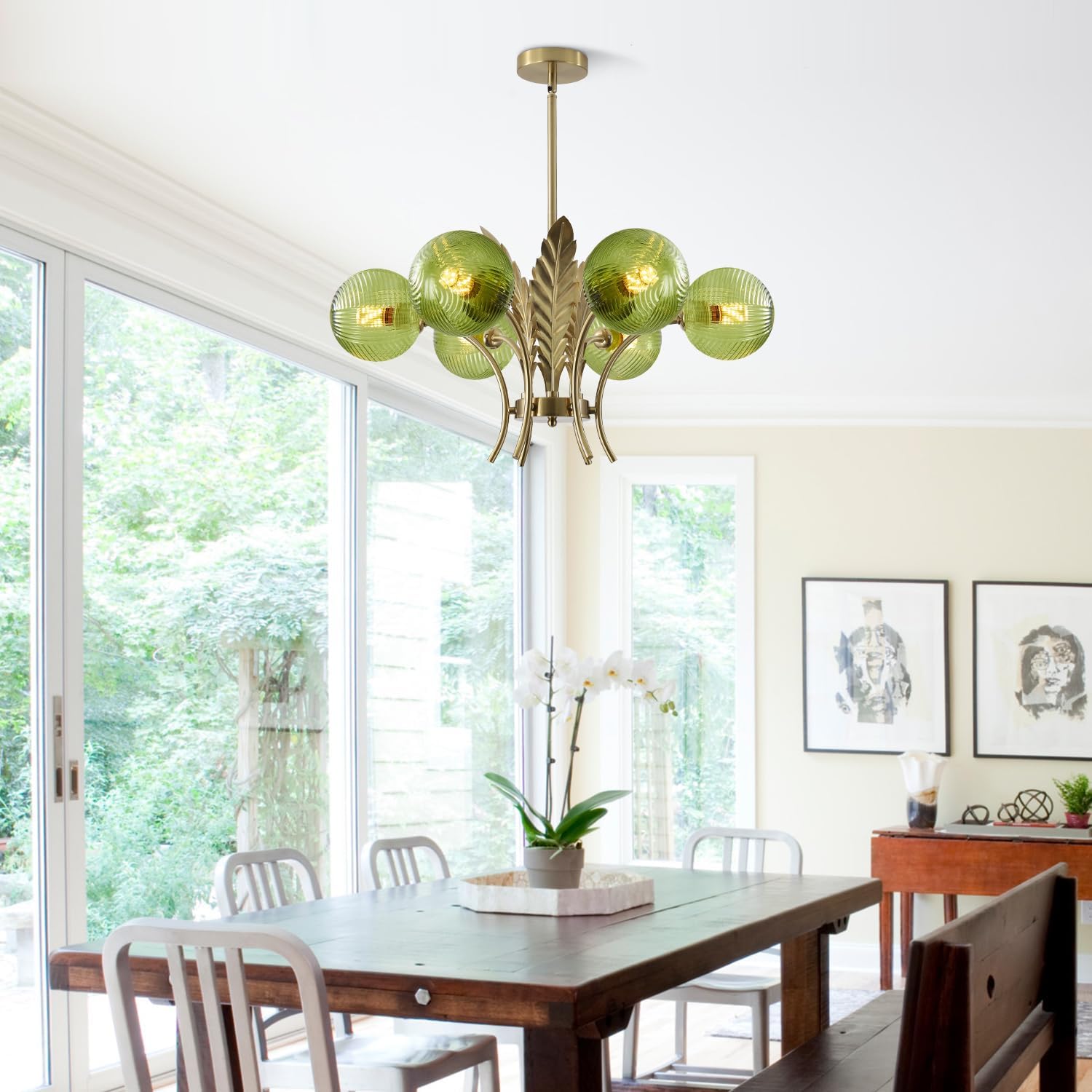 Dining room with a green glass chandelier, wooden table, and chairs.