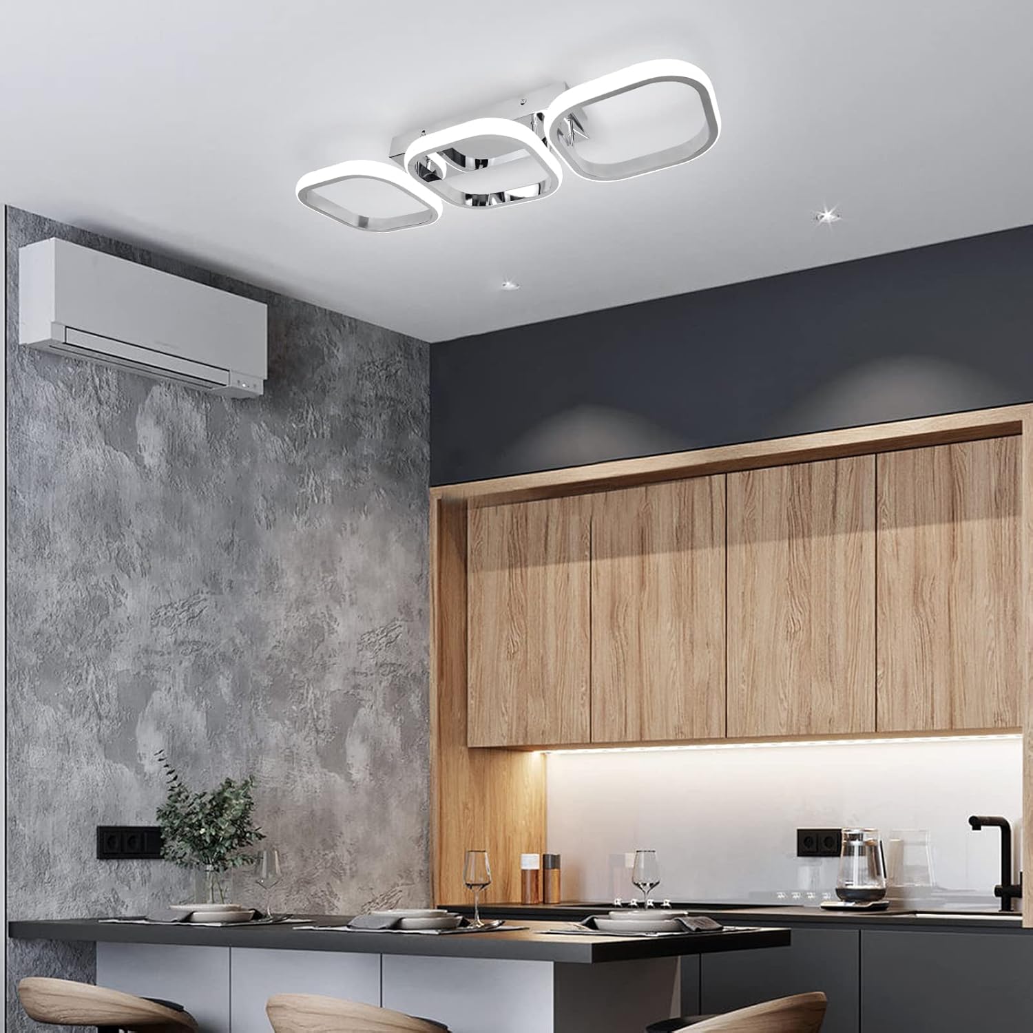 Modern kitchen with wooden cabinets, air conditioning unit, and ceiling lights.