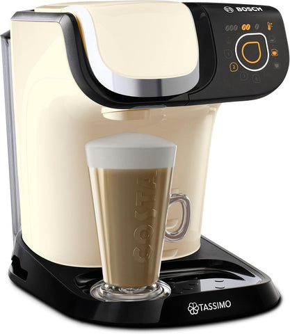 Tassimo coffee machine with a glass of coffee in front on a white background