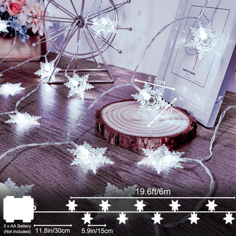 String lights shaped like snowflakes on a wooden surface with measurements displayed.