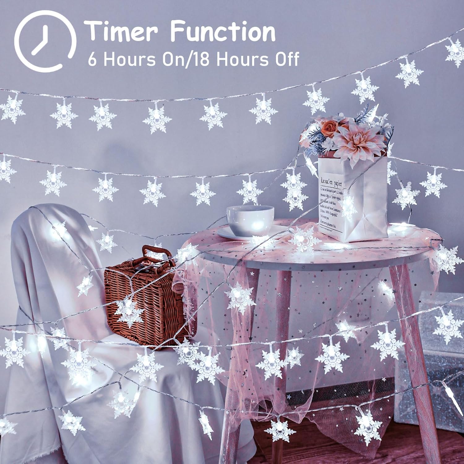 String lights with snowflake design in a room setting, featuring a table with a basket and flowers.