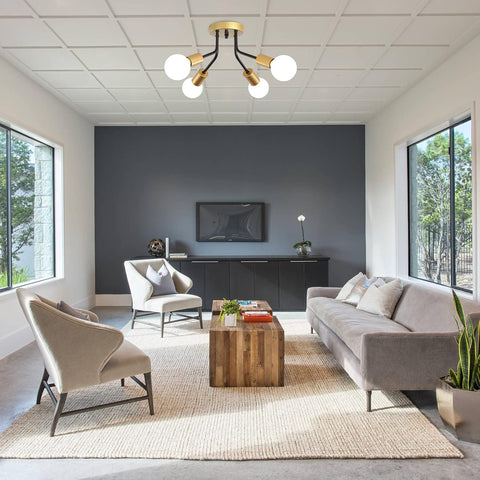 Modern living room with gray sofa, armchairs, and a coffee table.