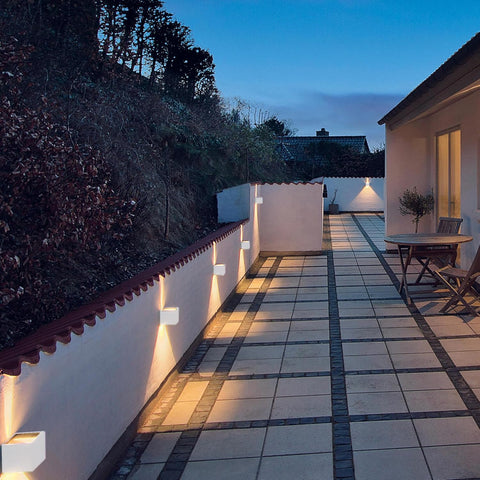 Evening view of a patio area with outdoor furniture and lighting.