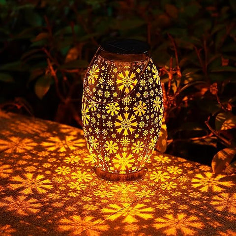 Lantern glowing with warm light on garden table

