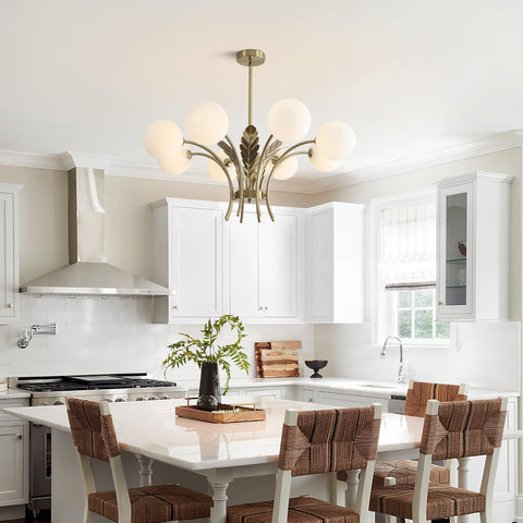 Modern kitchen with white cabinets, a chandelier, and a dining table with chairs.