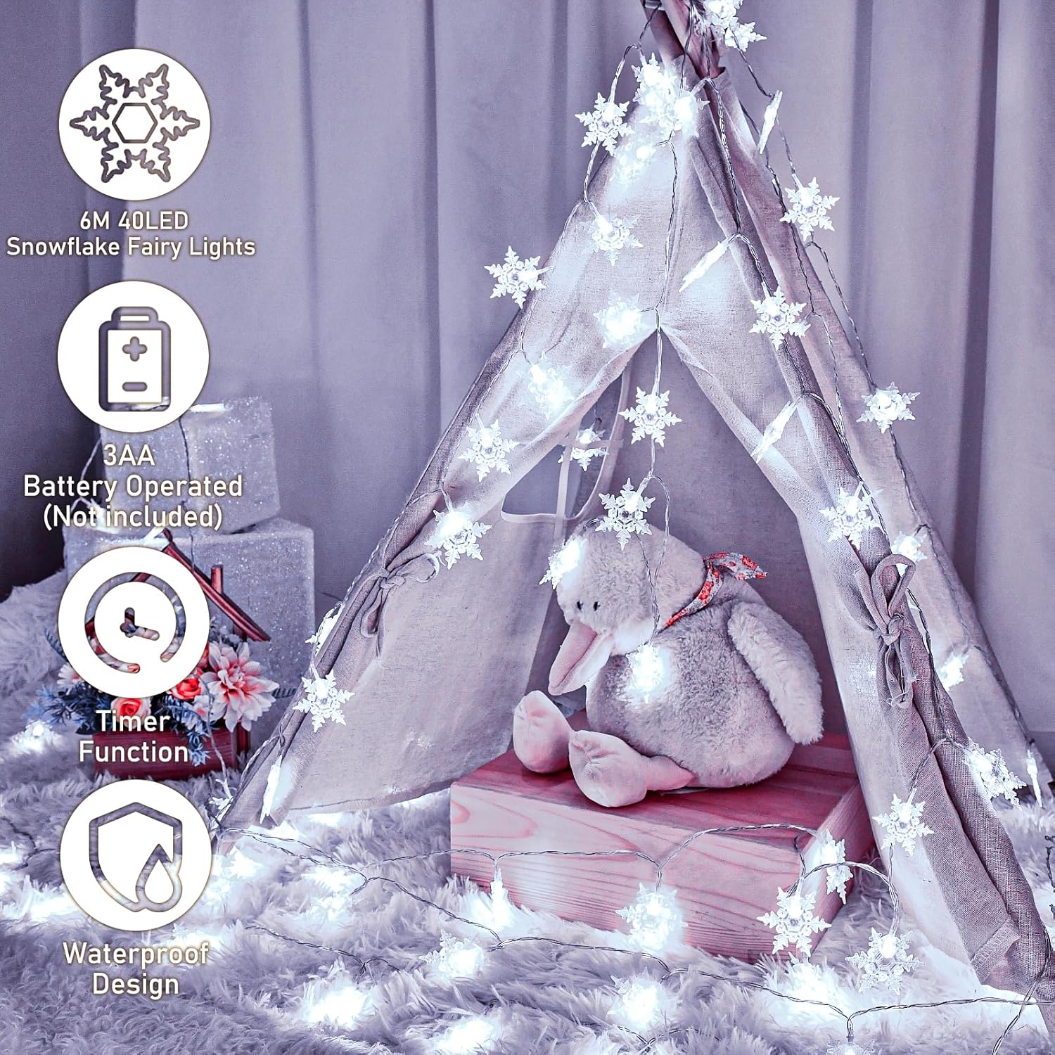 Children's teepee with snowflake fairy lights and a stuffed elephant toy on a soft purple background.