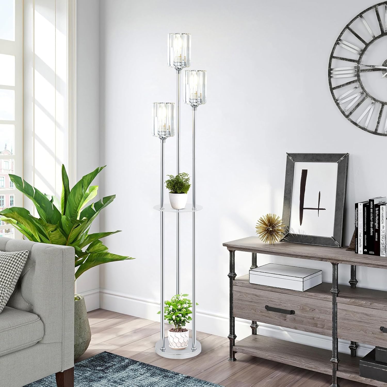 Living room with a gray sofa, floor lamp, plant, and wooden console table.