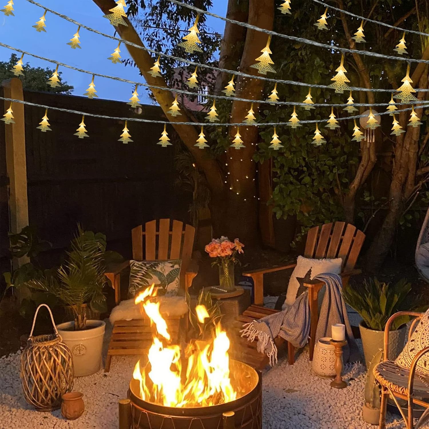 Outdoor patio with fire pit, string lights, and wooden chairs.