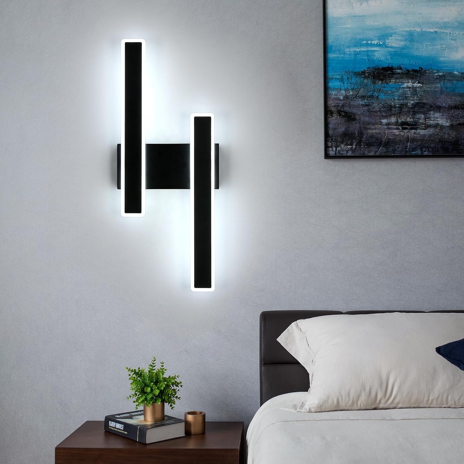 Modern wall sconces in a bedroom setting with a bed and nightstand.