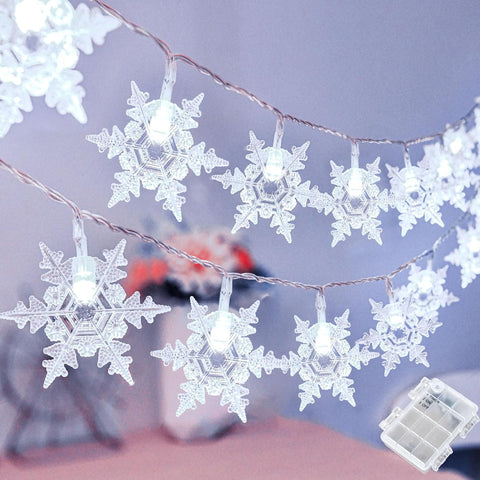 String of snowflake-shaped lights on a blurred background