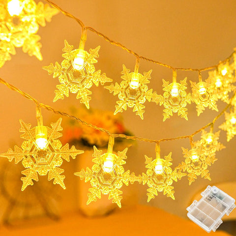 String lights with snowflake decorations on a warm-toned background