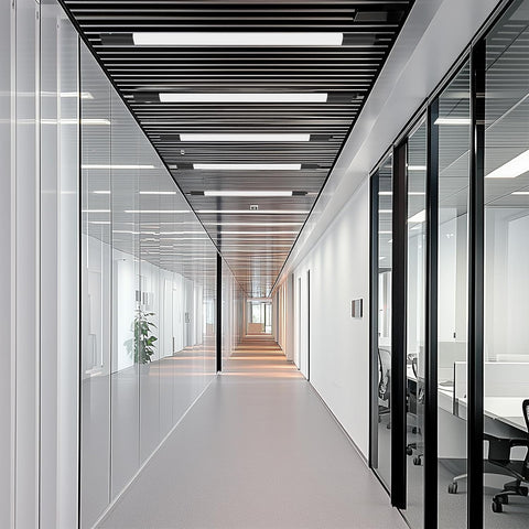 Modern office hallway with glass walls and ceiling lights