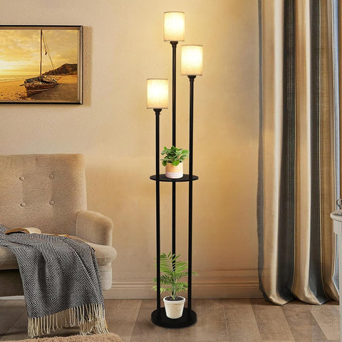 Three-tiered floor lamp with plants in a living room setting