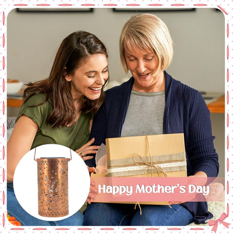 Two women looking at a gift box with a 'Happy Mother's Day' banner and a copper container inset.