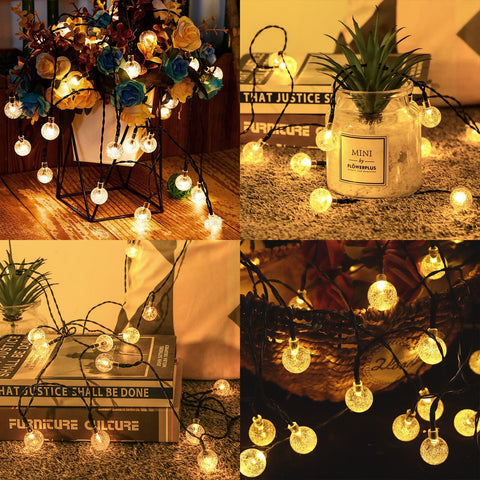 String lights with decorative elements on a wooden surface, books, and a vase.