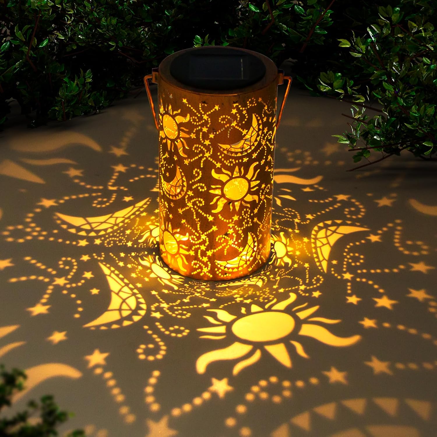 Decorative solar lantern casting patterns on the ground with greenery around.