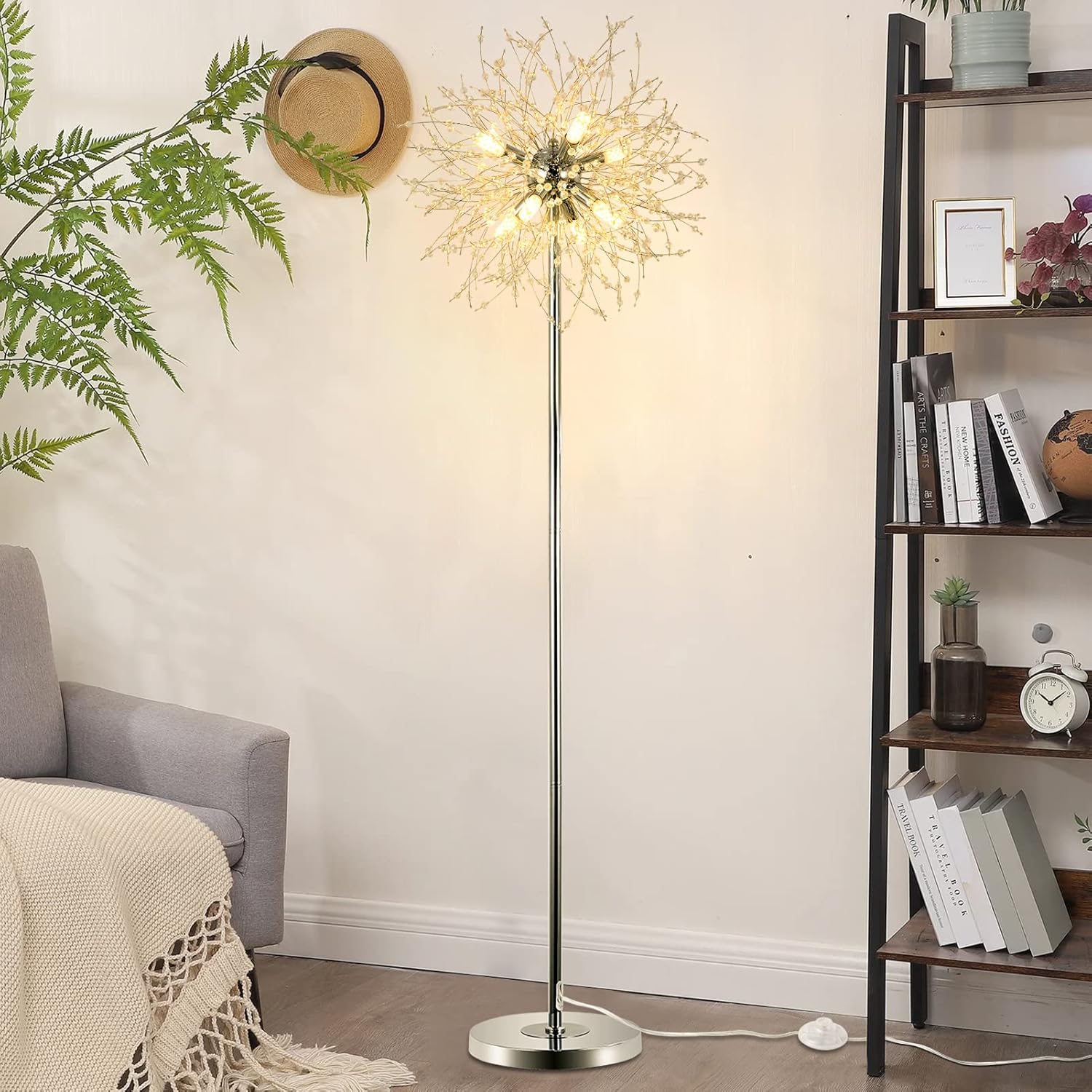 Decorative floor lamp in a living room setting with a bookshelf and plant.