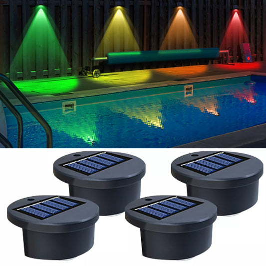 Set of 8 solar-powered wall lights illuminating a garden fence.

