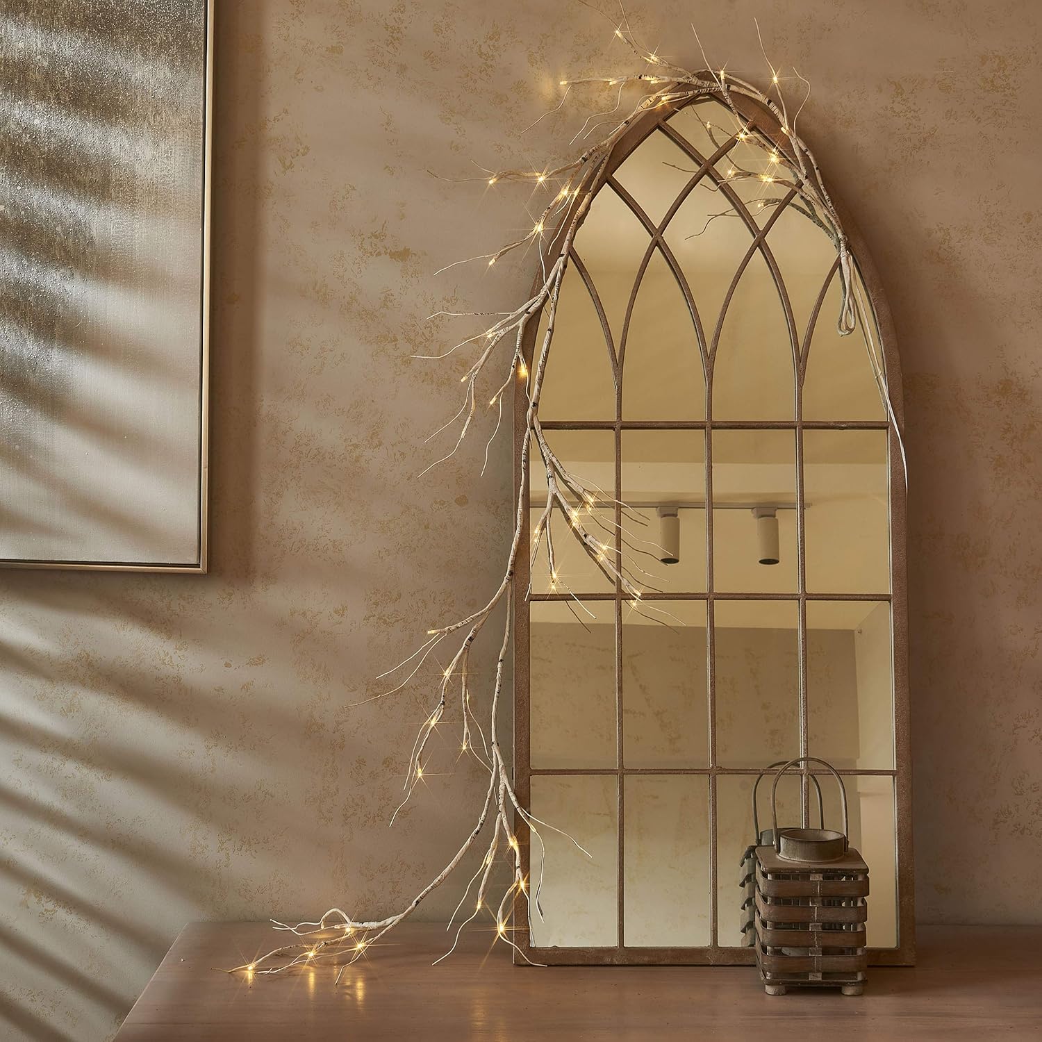Decorative mirror with fairy lights on a textured wall