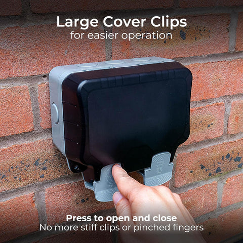 Hand pressing a large cover clip on a brick wall with text about its ease of use.