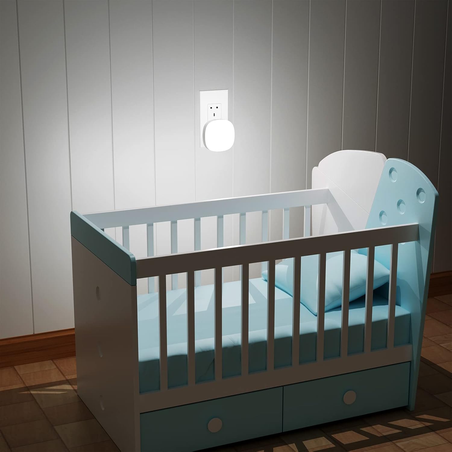Baby crib with blue and gray color scheme in a room with wooden flooring and white walls.