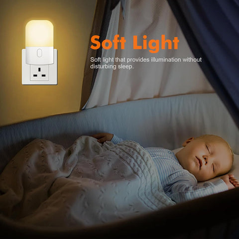 Baby sleeping in a crib with a night light labeled 'Soft Light' on a yellow wall.