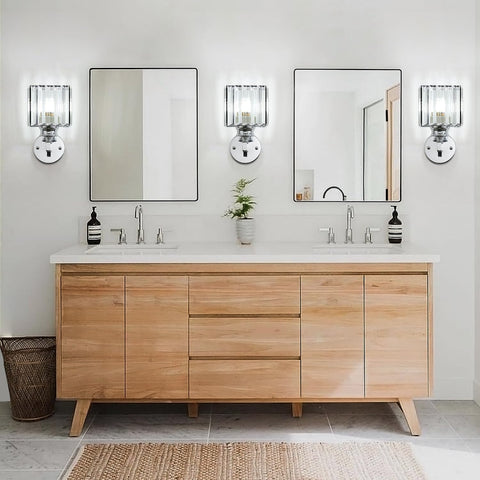 Bathroom vanity with wooden cabinets, mirrors, and decorative items.