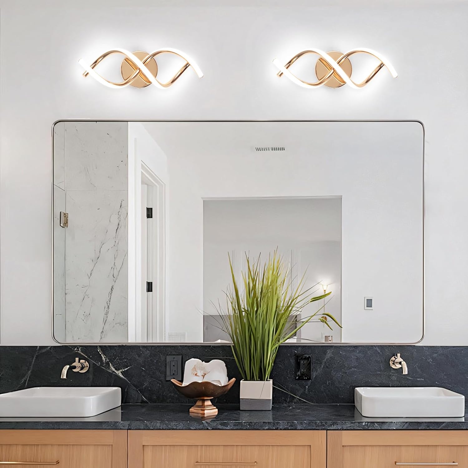 Bathroom with a large mirror, two lights above it, and a black countertop with white sinks.