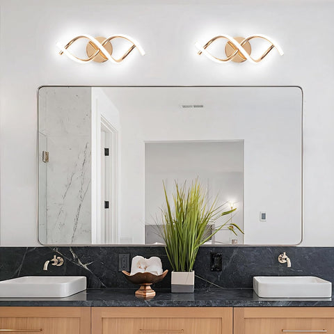 Bathroom with a large mirror, two lights above it, and a black countertop with white sinks.