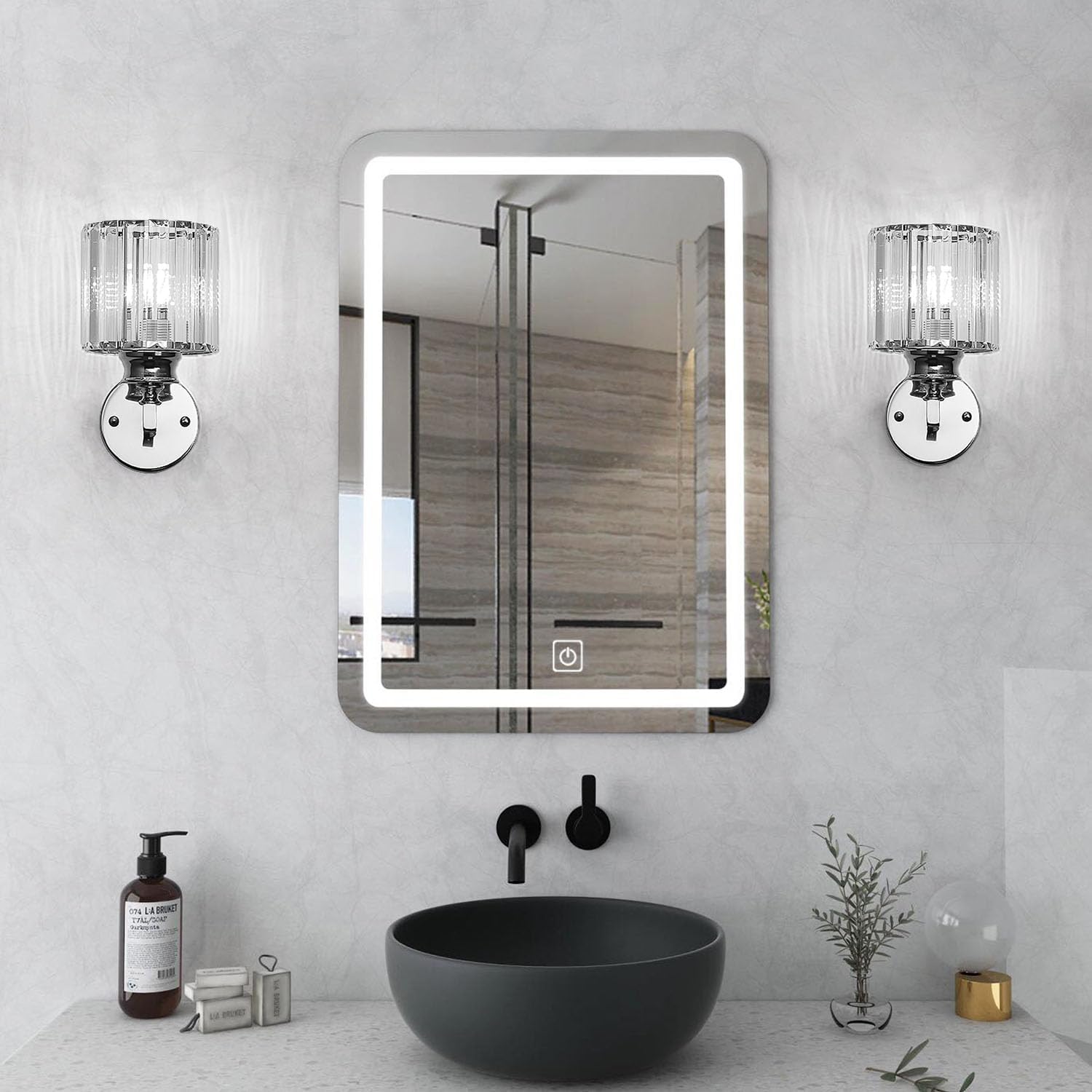 Bathroom with a mirror, sink, and decorative items on a light gray wall.