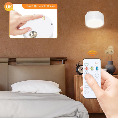Bedroom scene with a hand using a remote control to adjust a ceiling light.