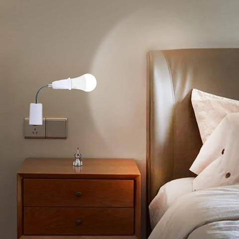 Bedroom scene with a wall-mounted lamp casting light onto a bed and nightstand.