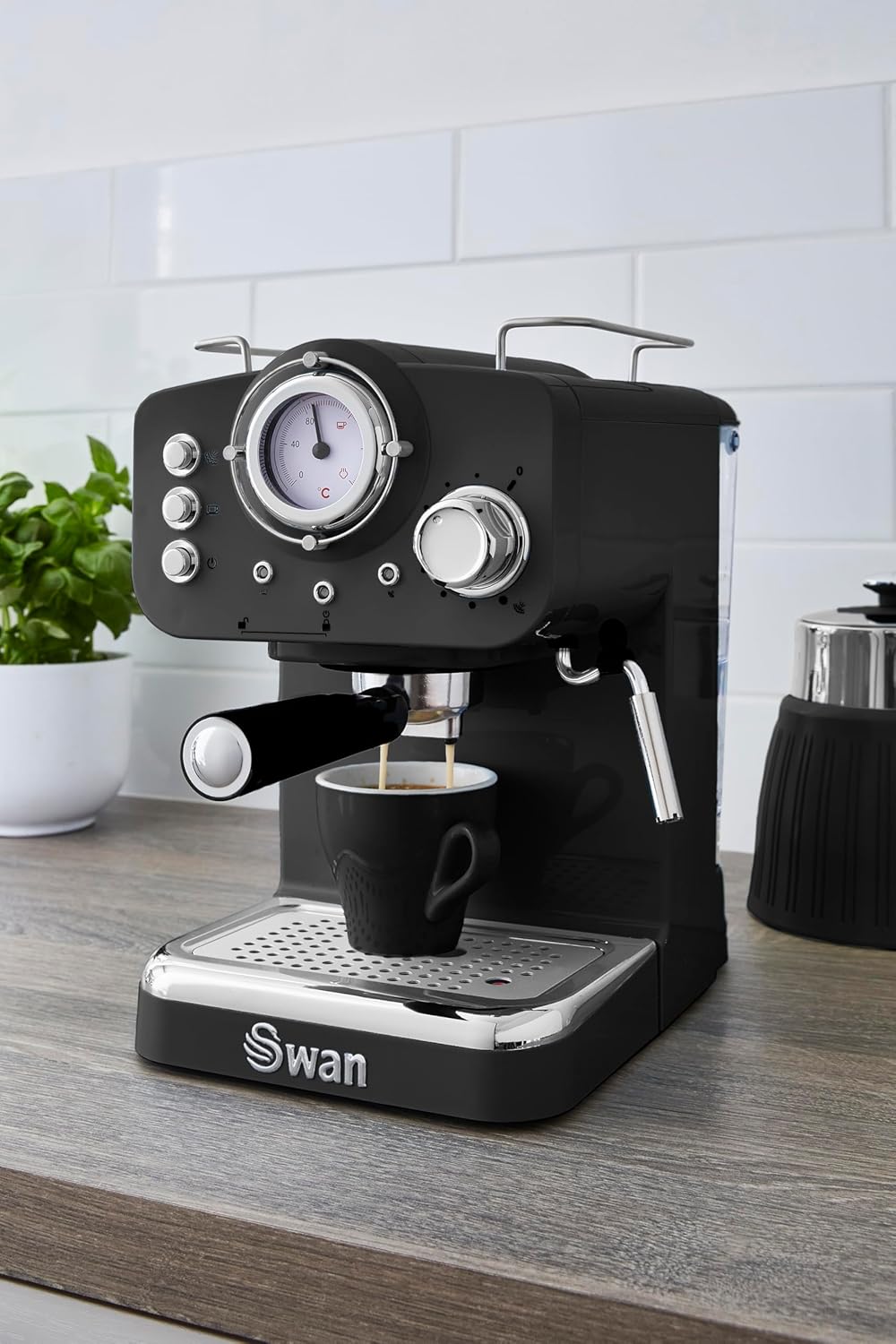 Black Swan espresso machine on a wooden surface with a white tiled wall in the background