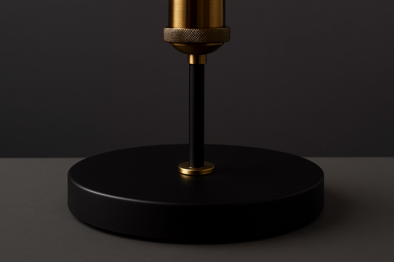 Black and gold lamp base on a dark background