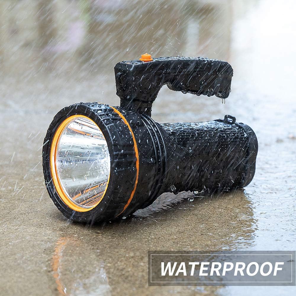 Black flashlight with orange rim being used in water, labeled 'Waterproof'.