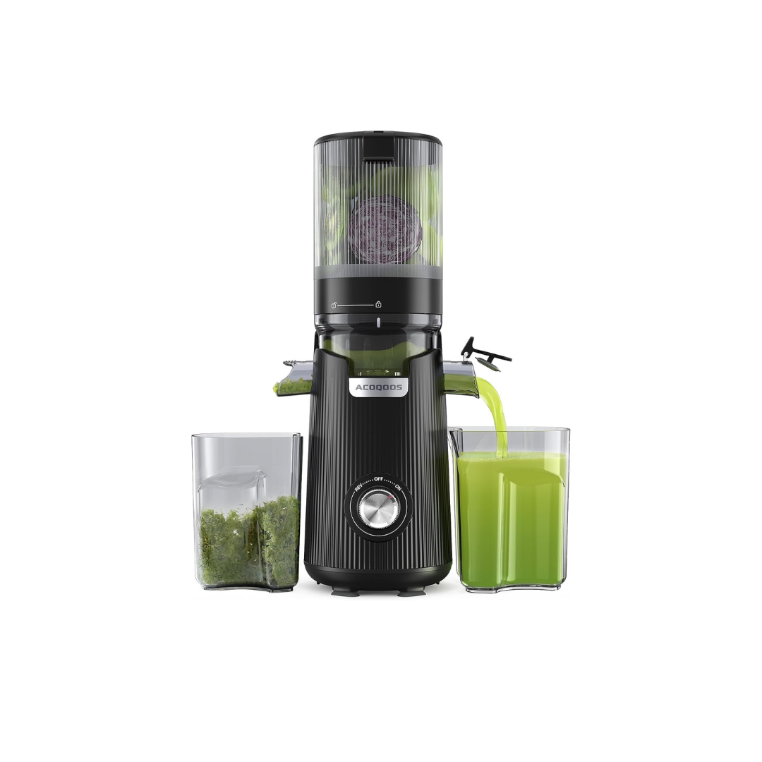 Black juice extractor with a glass of green juice and ingredients on a white background