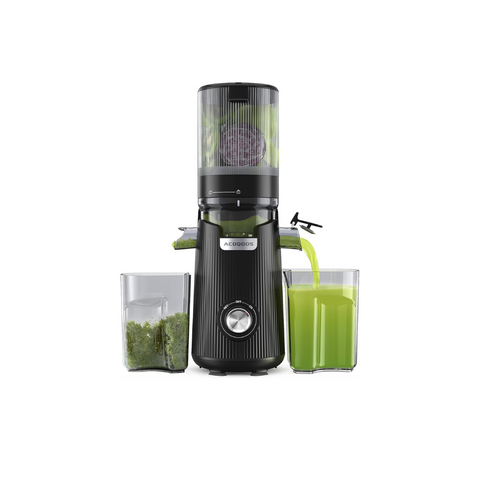 Black juice extractor with a glass of green juice and ingredients on a white background