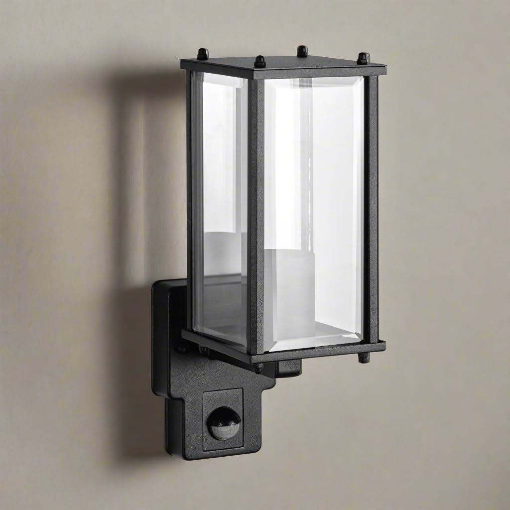 Black outdoor wall light fixture on a beige wall