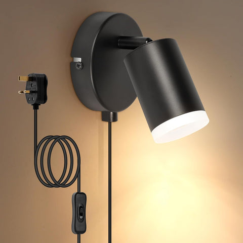 Black wall-mounted lamp with plug and socket on a neutral background