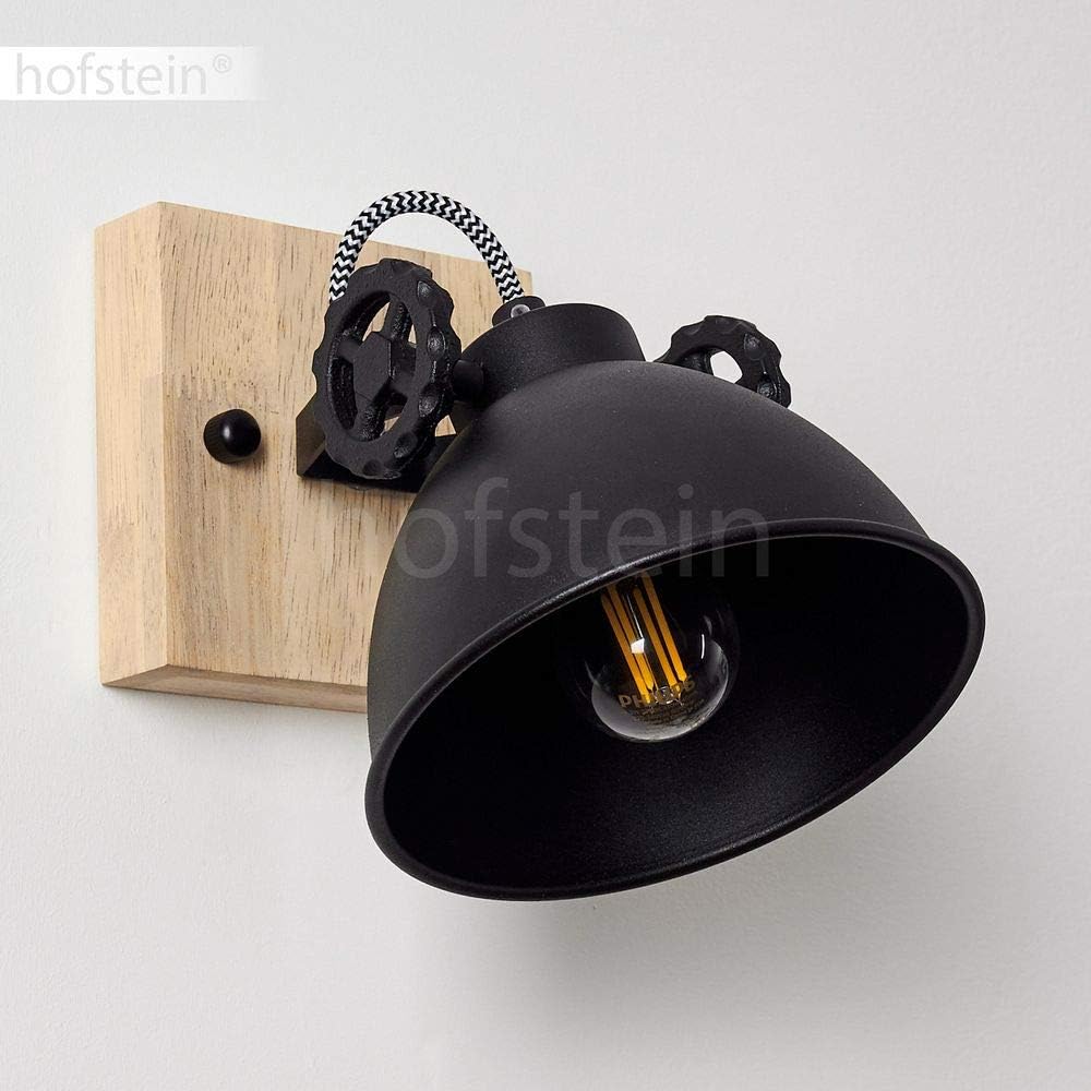 Black wall-mounted lamp with wooden base and visible bulb on a white background