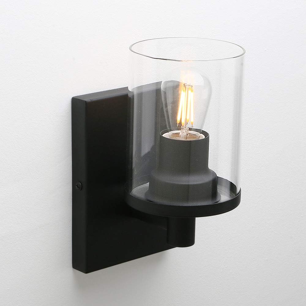 Black wall-mounted light fixture with a clear glass shade on a white background