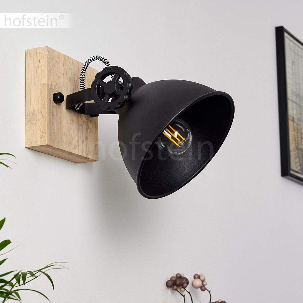 Black wall lamp with wooden base on a white wall, brand 'hofstein' visible
