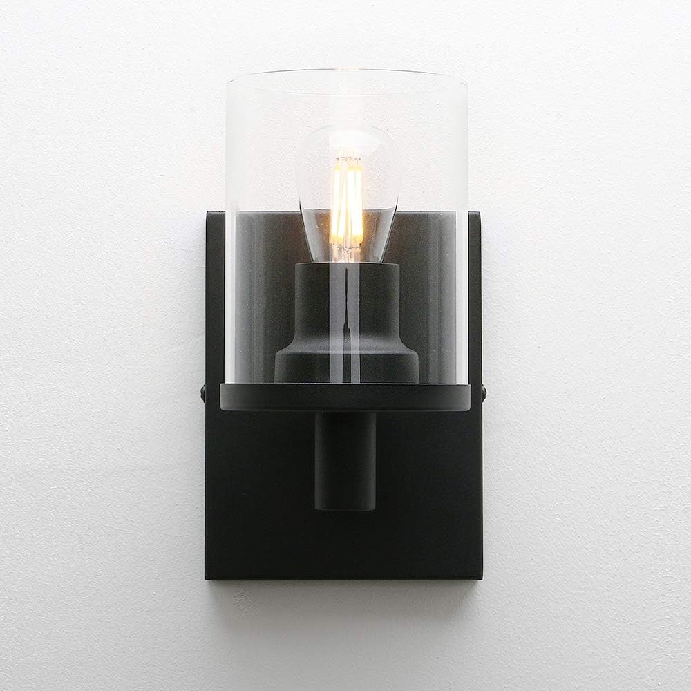 Black wall sconce with a clear glass cover on a white background