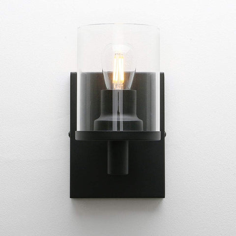 Black wall sconce with a clear glass cover on a white background