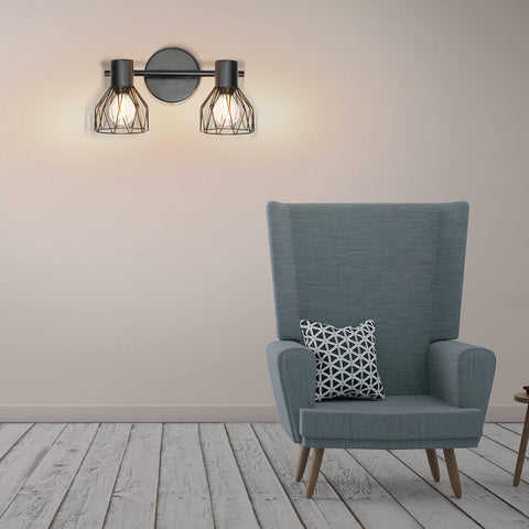 Blue armchair with a patterned pillow in a room with wall lights.