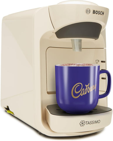 Bosch Tassimo coffee machine with a Cadbury branded mug on a white background
